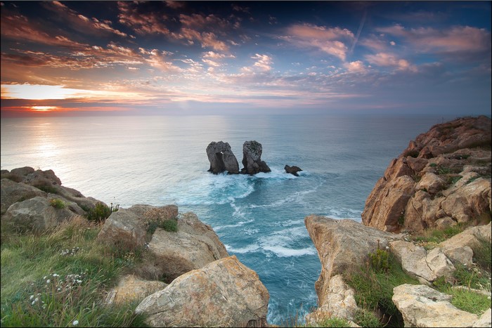Sea stacks and rocky cliffs at sunset