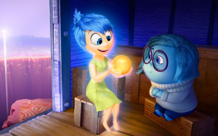 Joy and Sadness from Inside Out holding a memory orb