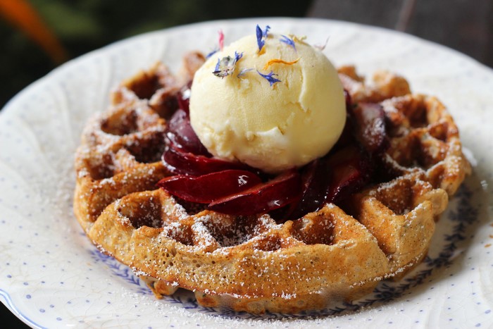 Waffle with ice cream and plums