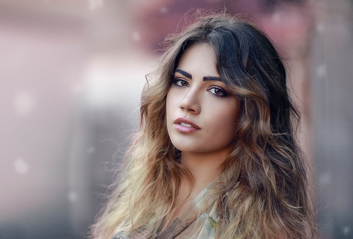 Woman with long wavy hair looking to the side