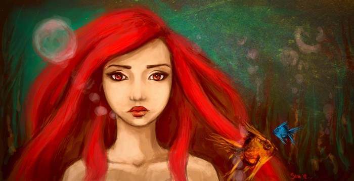 Redhead girl underwater with fish