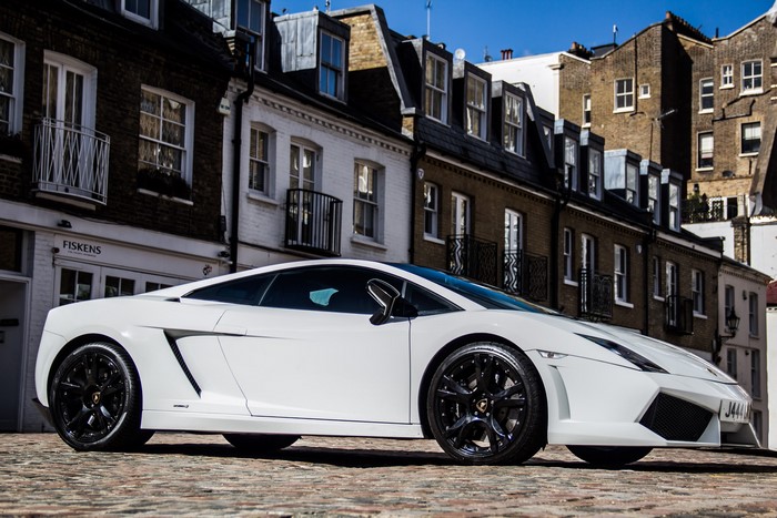 White Lamborghini Gallardo LP560-4 parked on cobblestone street