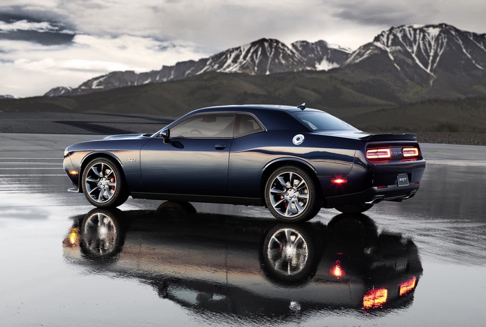 Blue Dodge Challenger SRT Hellcat on wet road with mountains