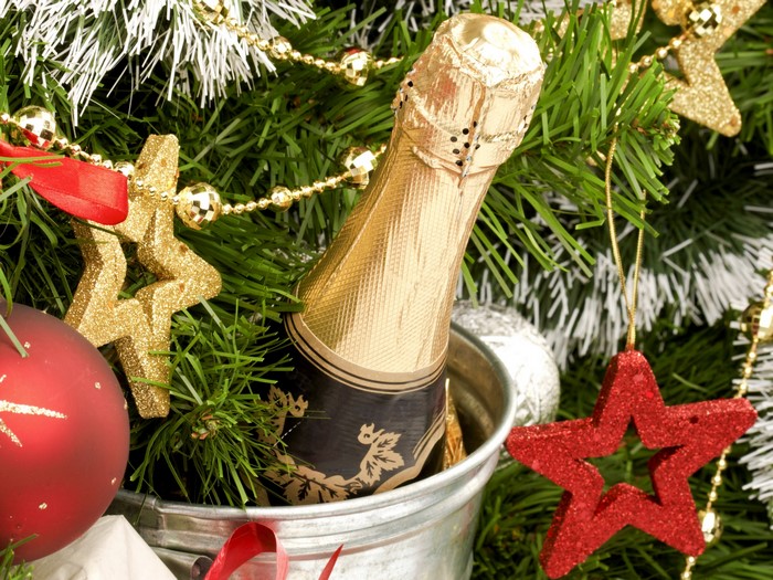 Champagne bottle and Christmas ornaments on a tree