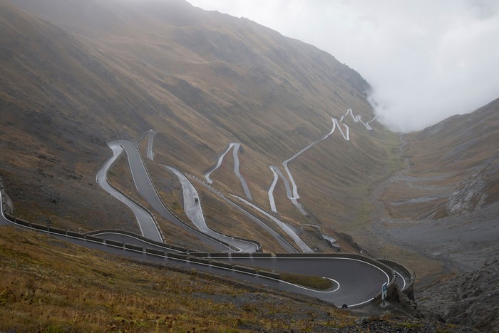 Stelvio Pass road in the Italian Alps with fog