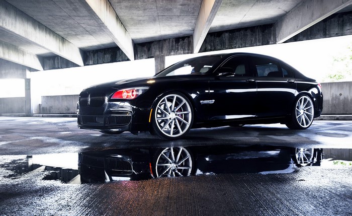Black BMW 750LI parked in a concrete structure