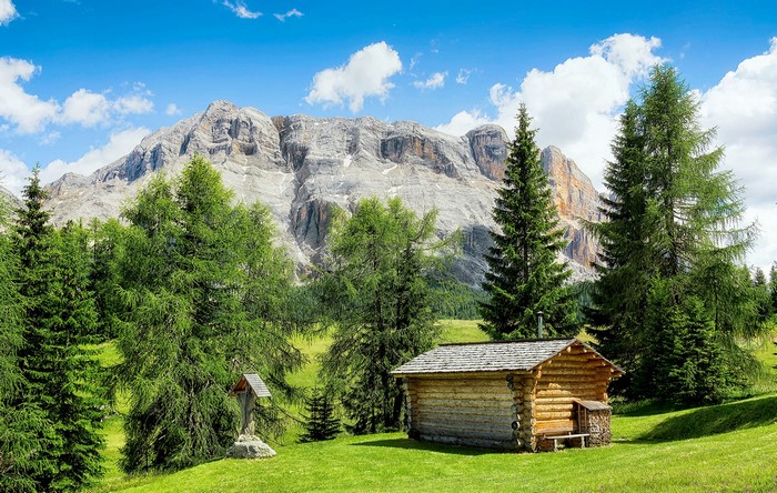 Log cabin in the Italian Alps with mountains