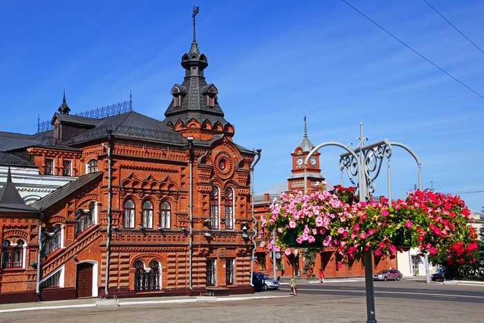 Vladimir, Russia: Red Brick Building with Clock Tower and Flowers
