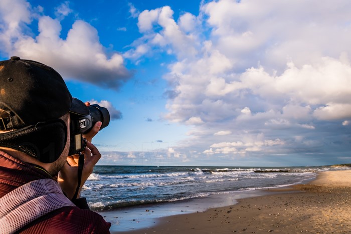 Photographer with camera on Baltic Sea coast, Russia