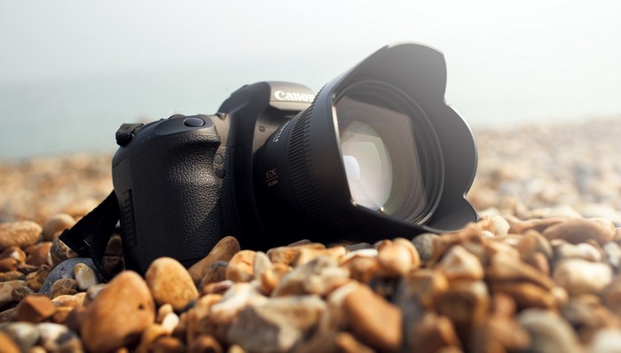 Canon DSLR camera on a pebble beach