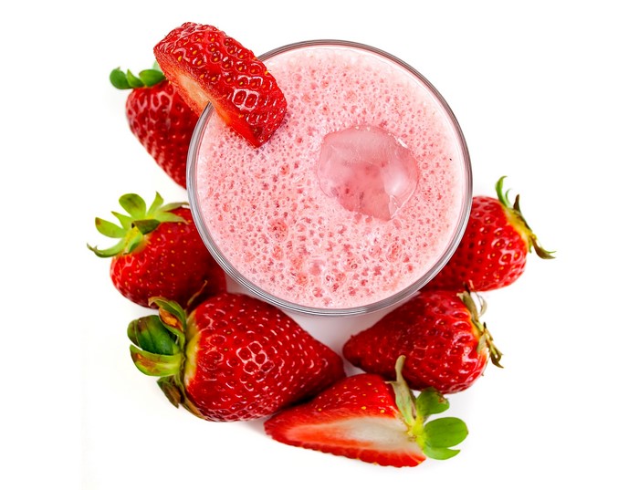 Strawberry smoothie in a glass with fresh strawberries