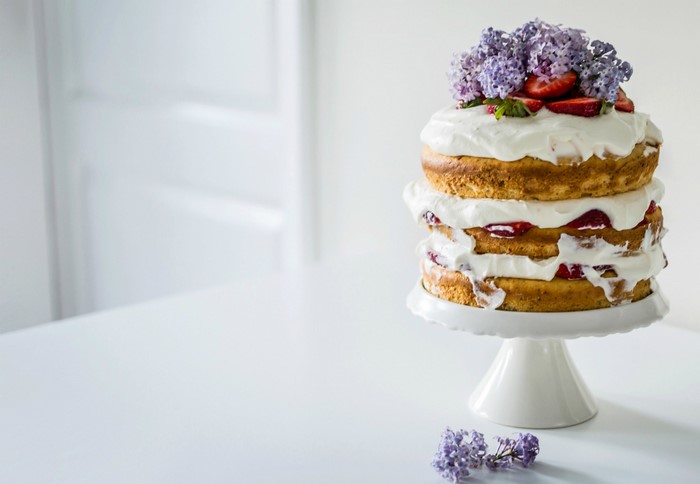 Naked cake with strawberries and lilac