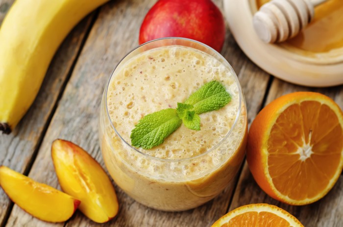 Fruit smoothie with banana, orange, and peach