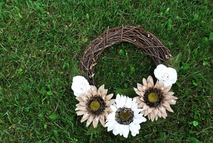 Grapevine wreath with burlap sunflowers and roses on grass