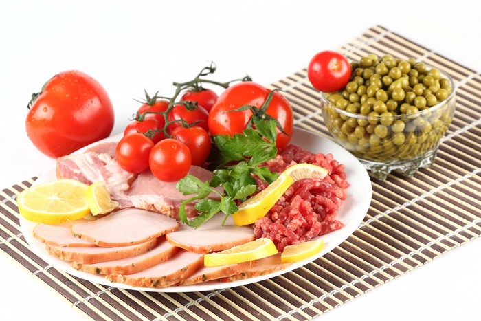 Ham, Tomatoes, Lemons, and Peas on a Plate