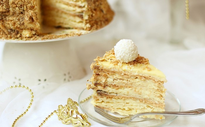 Slice of layered cake with coconut ball on top