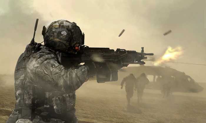 Soldier firing machine gun near helicopter