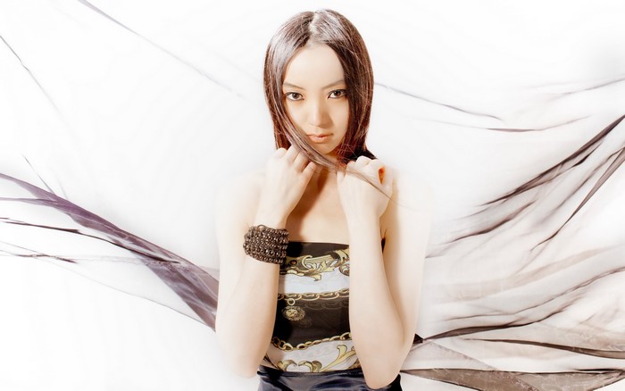 Asian woman with brown hair and bracelet