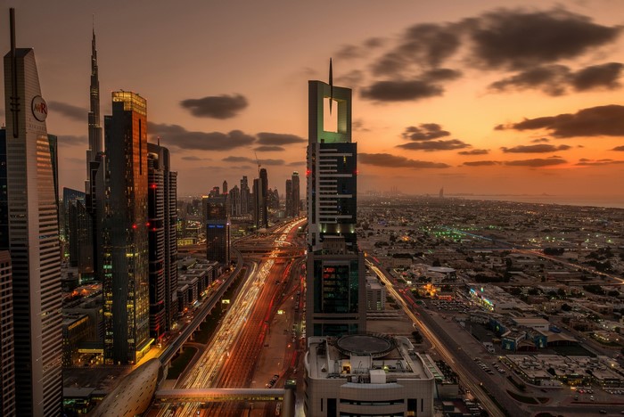 Dubai skyscrapers and highway at sunset