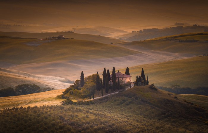Tuscan Villa surrounded by rolling hills and fog