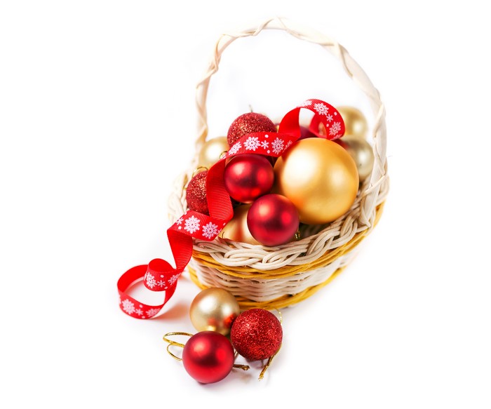 Christmas balls in a wicker basket with red ribbon