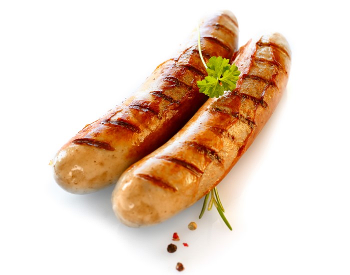 Two grilled sausages with parsley and peppercorns