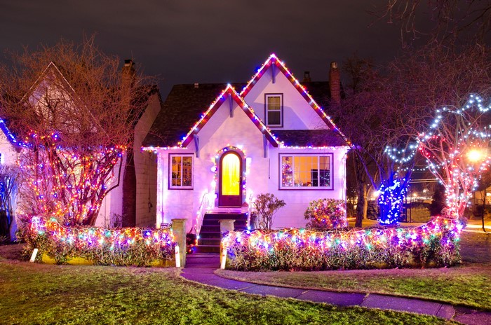House decorated with colorful Christmas lights at night