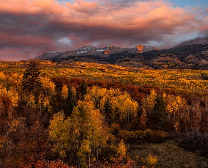 Autumn forest and mountains at sunset
