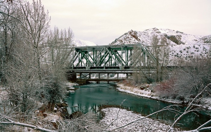 Green bridge over a river in winter near Morgan, Utah