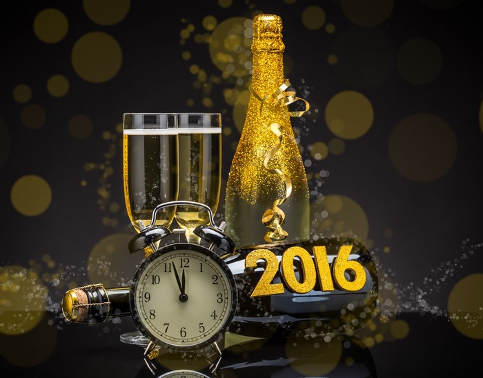 Champagne bottle, glasses, alarm clock, and 2016 text