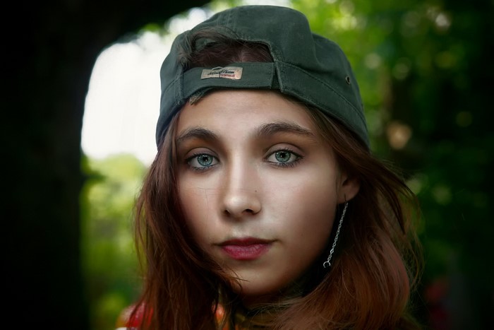 Girl with brown hair wearing a baseball cap