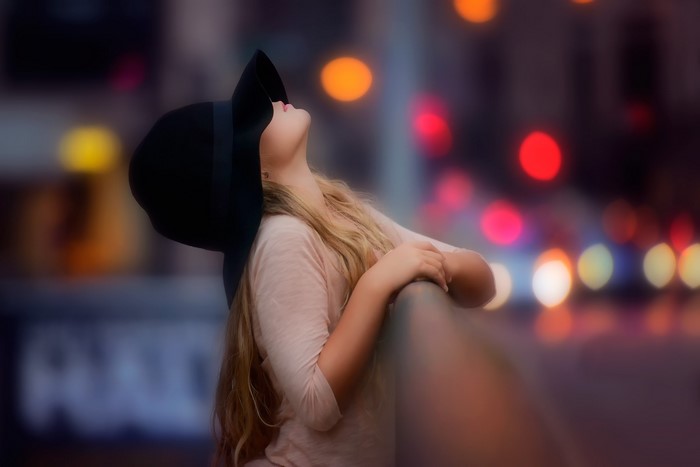 Blonde girl wearing a black hat