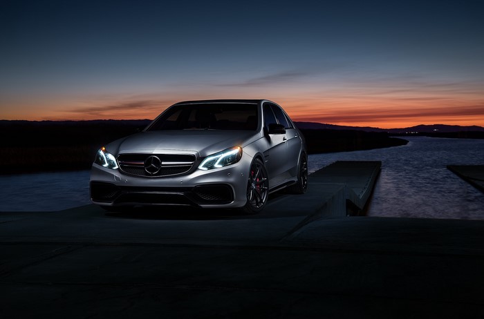 Silver Mercedes-Benz E63 AMG S sedan at dusk