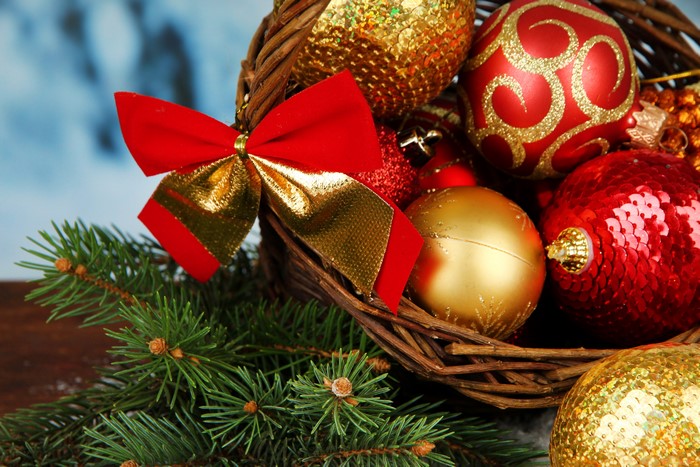 Christmas ornaments in a basket with pine branches