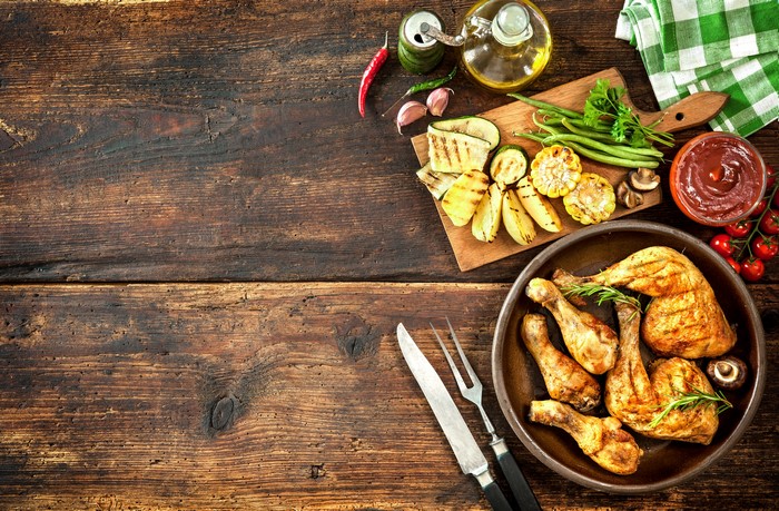 Roast Chicken and Grilled Vegetables on Wooden Table
