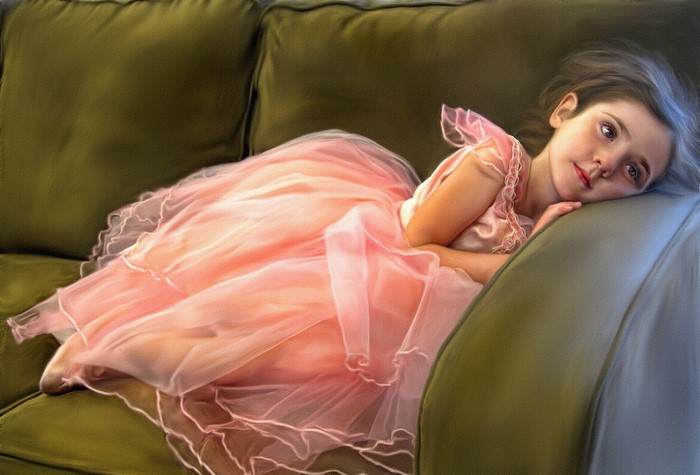Girl in a pink dress lying on a couch