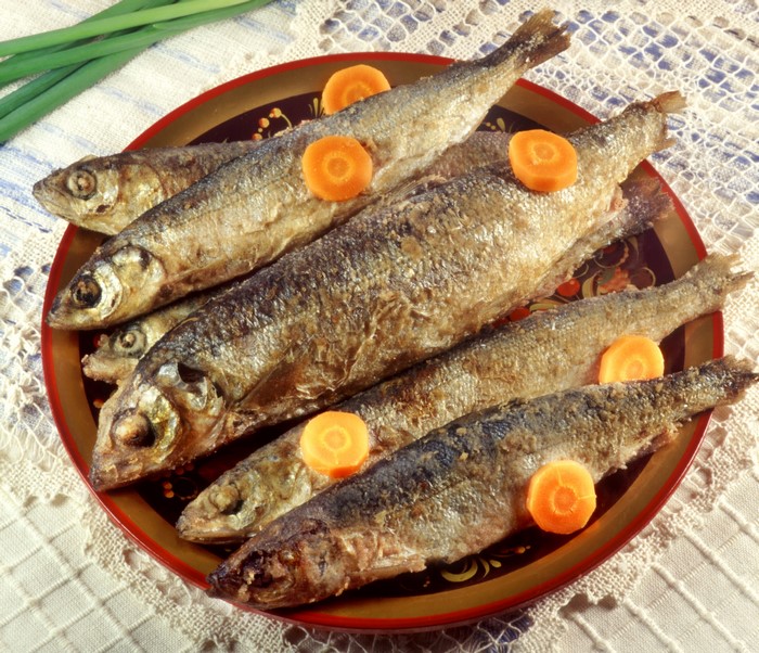 Fried Fish with Carrot Slices on a Decorative Plate