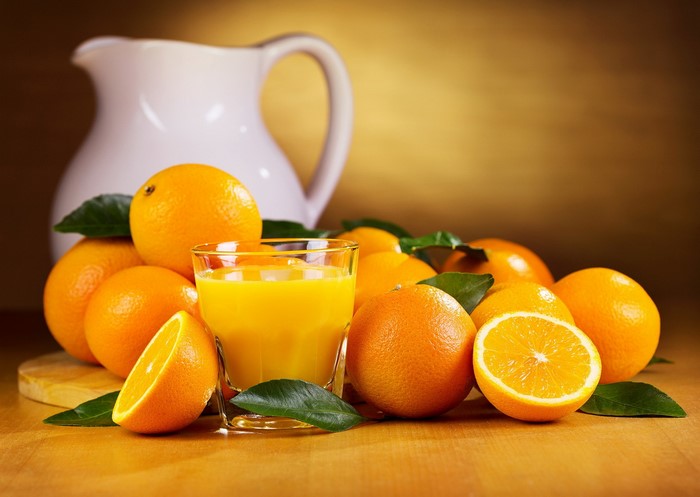 Oranges and orange juice in a glass with a pitcher