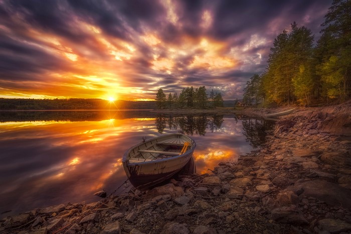 Boat on a lake at sunset in Ringerike, Norway
