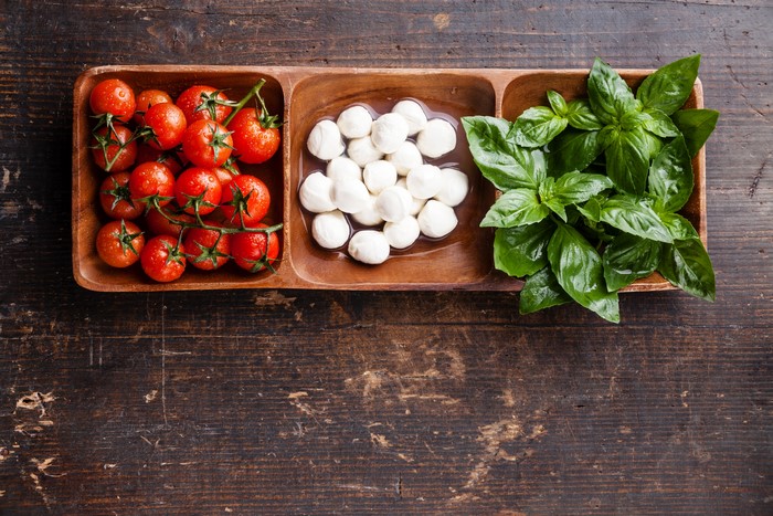 Tomatoes, Mozzarella, and Basil on Wooden Platter