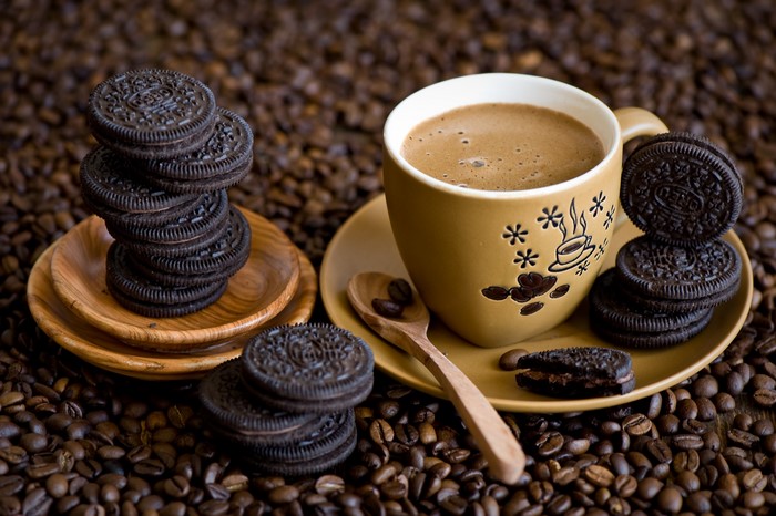 Coffee cup with cookies and coffee beans