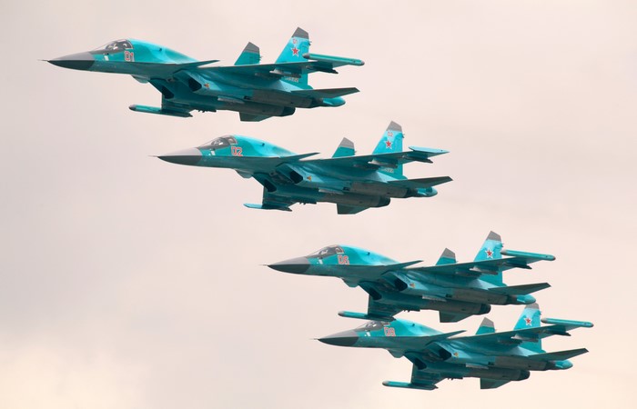Five fighter airplanes in formation