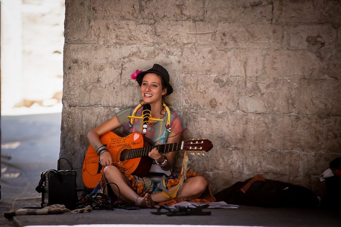 Woman playing guitar and singing