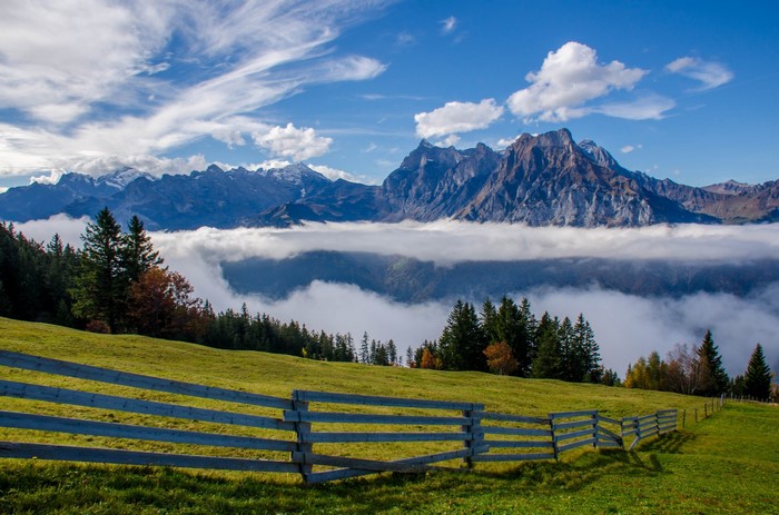 Uri Alps Switzerland Mountains with Fog and Fence