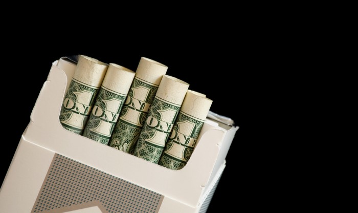 Cigarette pack filled with rolled dollar bills