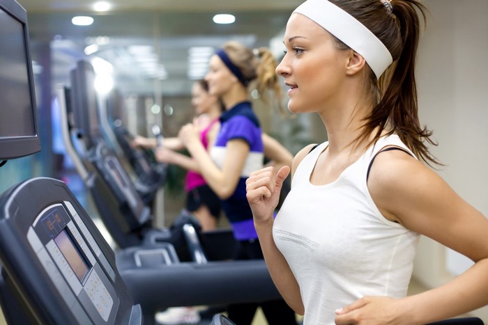 Women running on treadmills in a gym