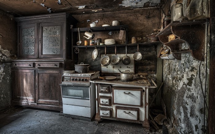 Abandoned kitchen with old stove and cabinets