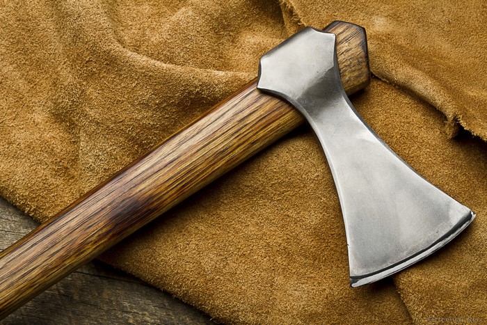 Close-up of a battle axe on brown leather