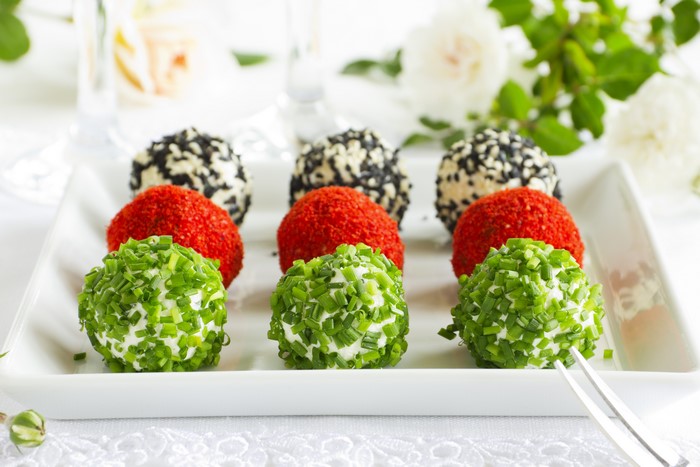 Appetizer cheese balls with chives, paprika, and sesame seeds