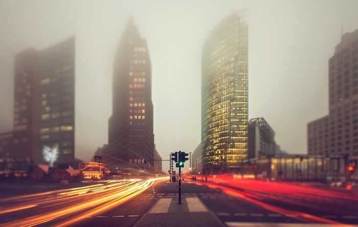 Berlin street in fog with light trails